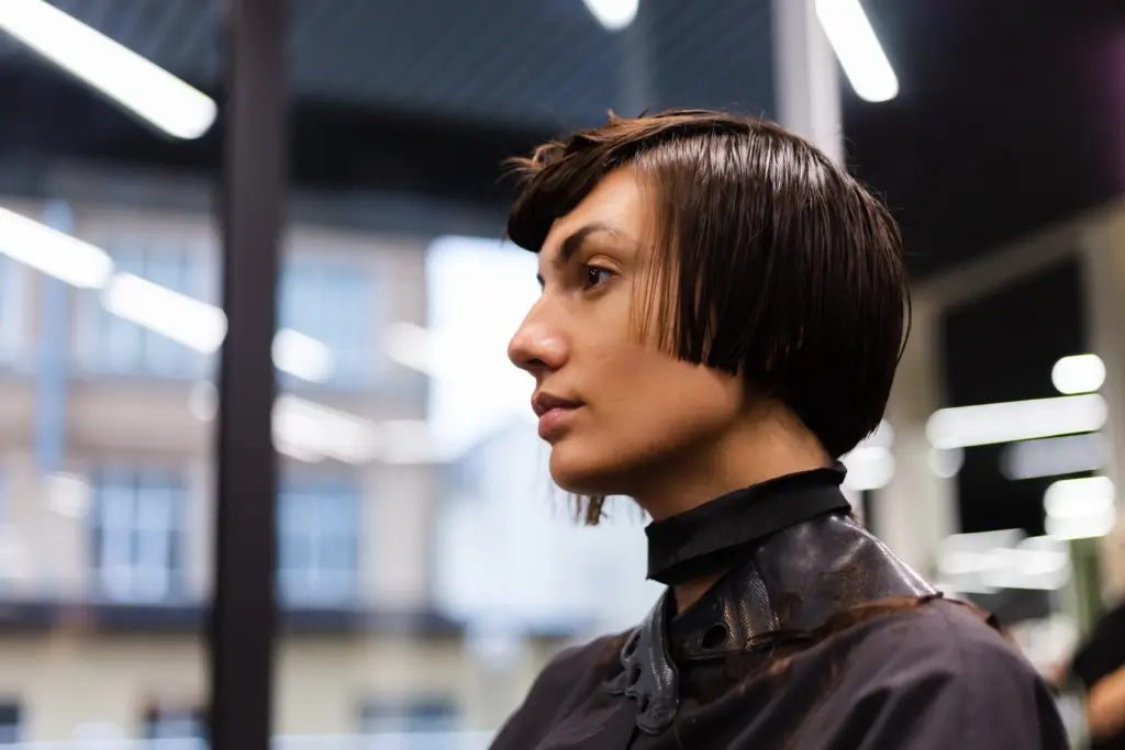 professional girl hairdresser makes client haircut girl is sitting mask beauty salon Short Haircuts